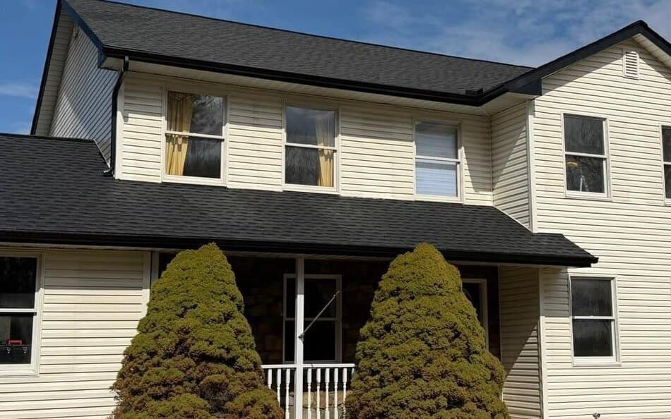 After — Two-story vinyl-sided home, algae streaks soft washed away